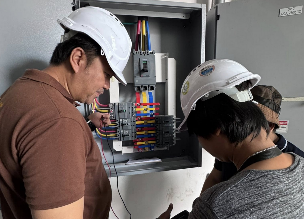 energy auditor checking panelboard