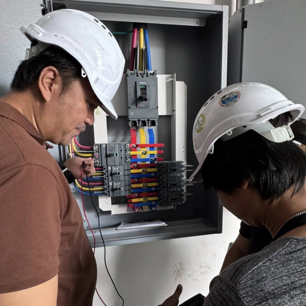 energy auditor checking panelboard